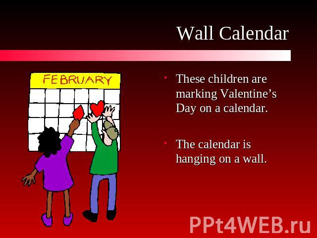 Wall Calendar These children are marking Valentine’s Day on a calendar.The calendar is hanging on a wall.